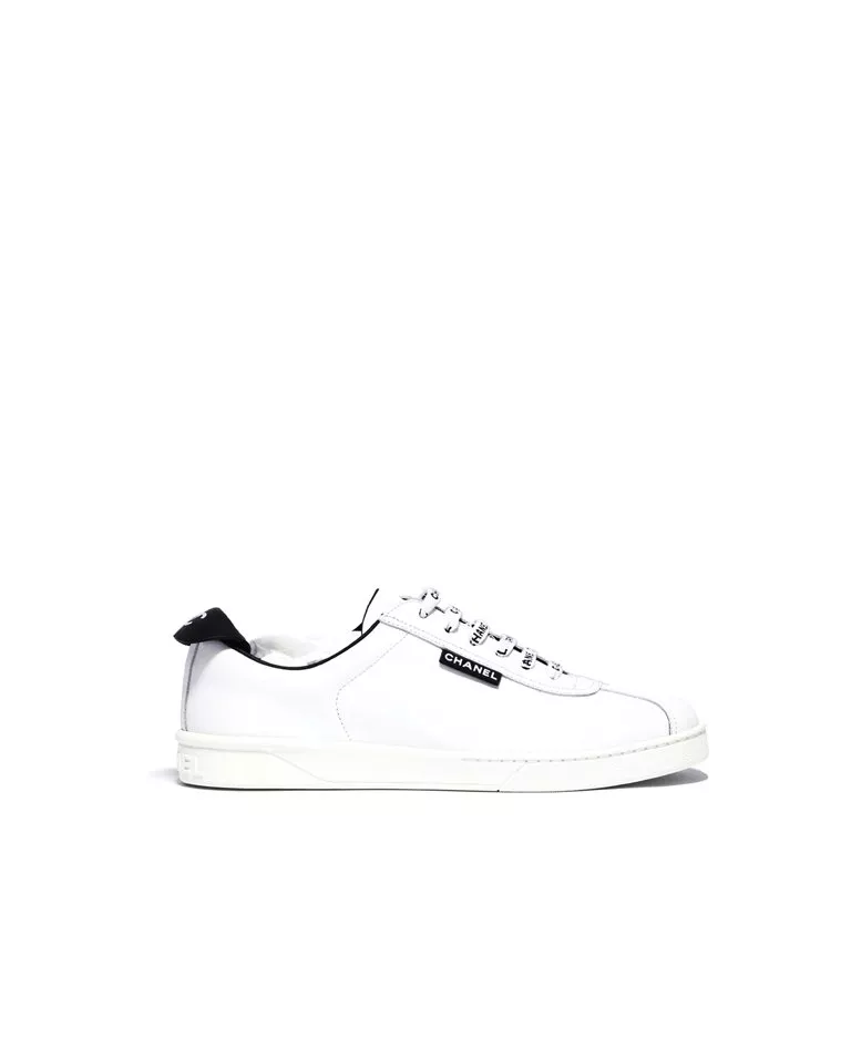 Chanel logo white calfskin sneakers with all over logo shoe laces side in a full white background