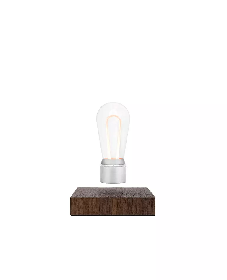 Flyte chrome silver Marconi Nikola hovering bulb hovering upon a walnut wood base in a full white background