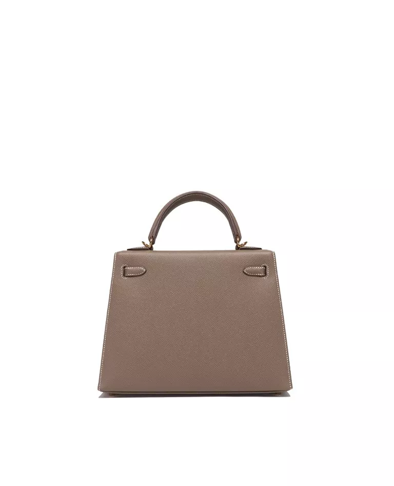Hermes Kelly 25 etoupe with gold hardware back in a full white background