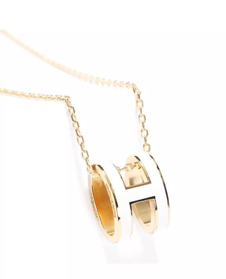 Hermes pop h pendant white and gold hardware details in a full white background
