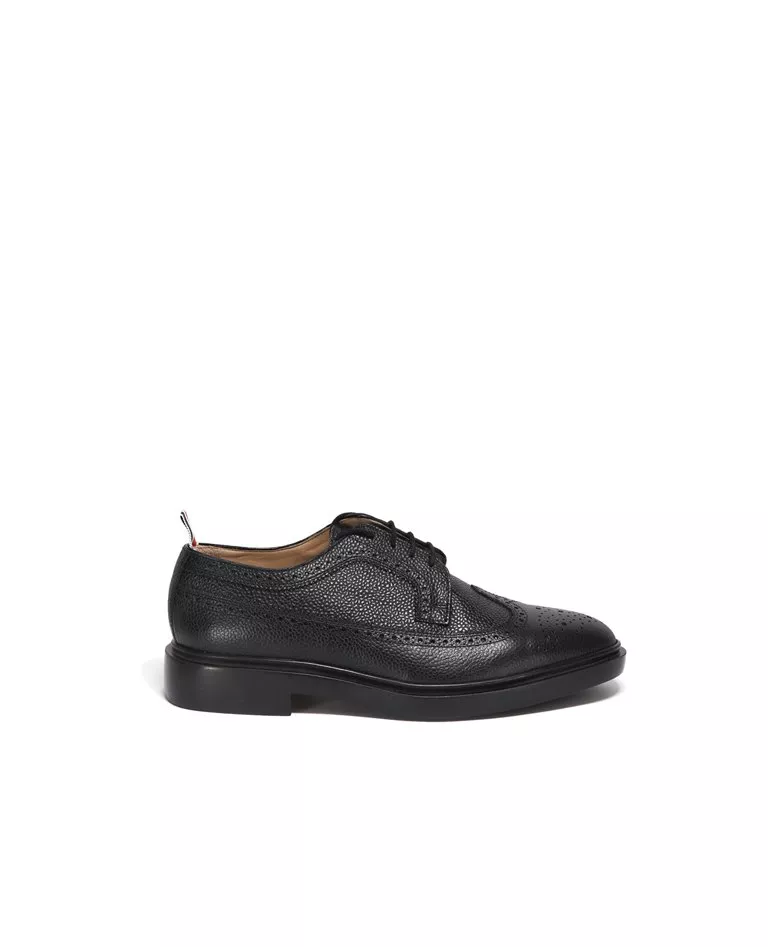 Thom Browne black classic longwing brogue with leather sole side in a full white background