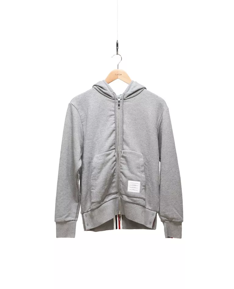 Thom Browne grey back grosgrain stripe hoodie with zipper front in a full white background