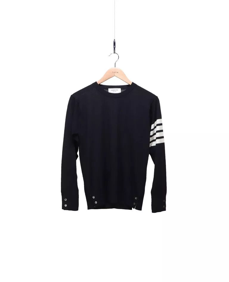 Thom Browne navy blue 4-bar merino wool pullover with white intarsia 4-bar stripes front in a full white background