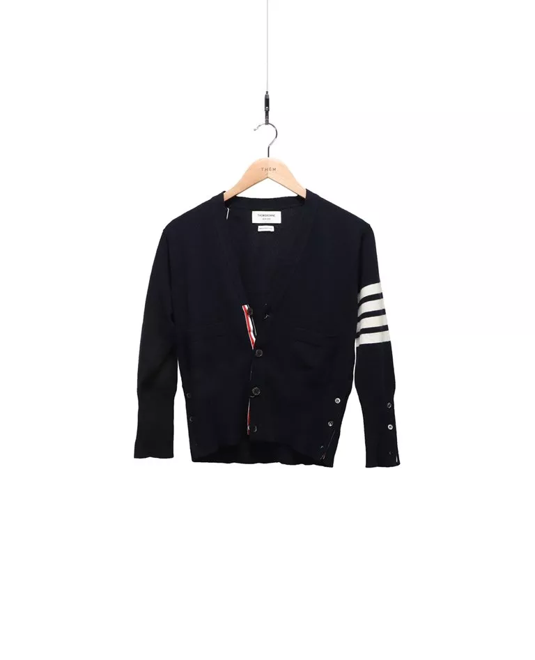 Thom Browne navy blue 4-bar cashmere cardigan with white intarsia 4-bar stripes front in a full white background